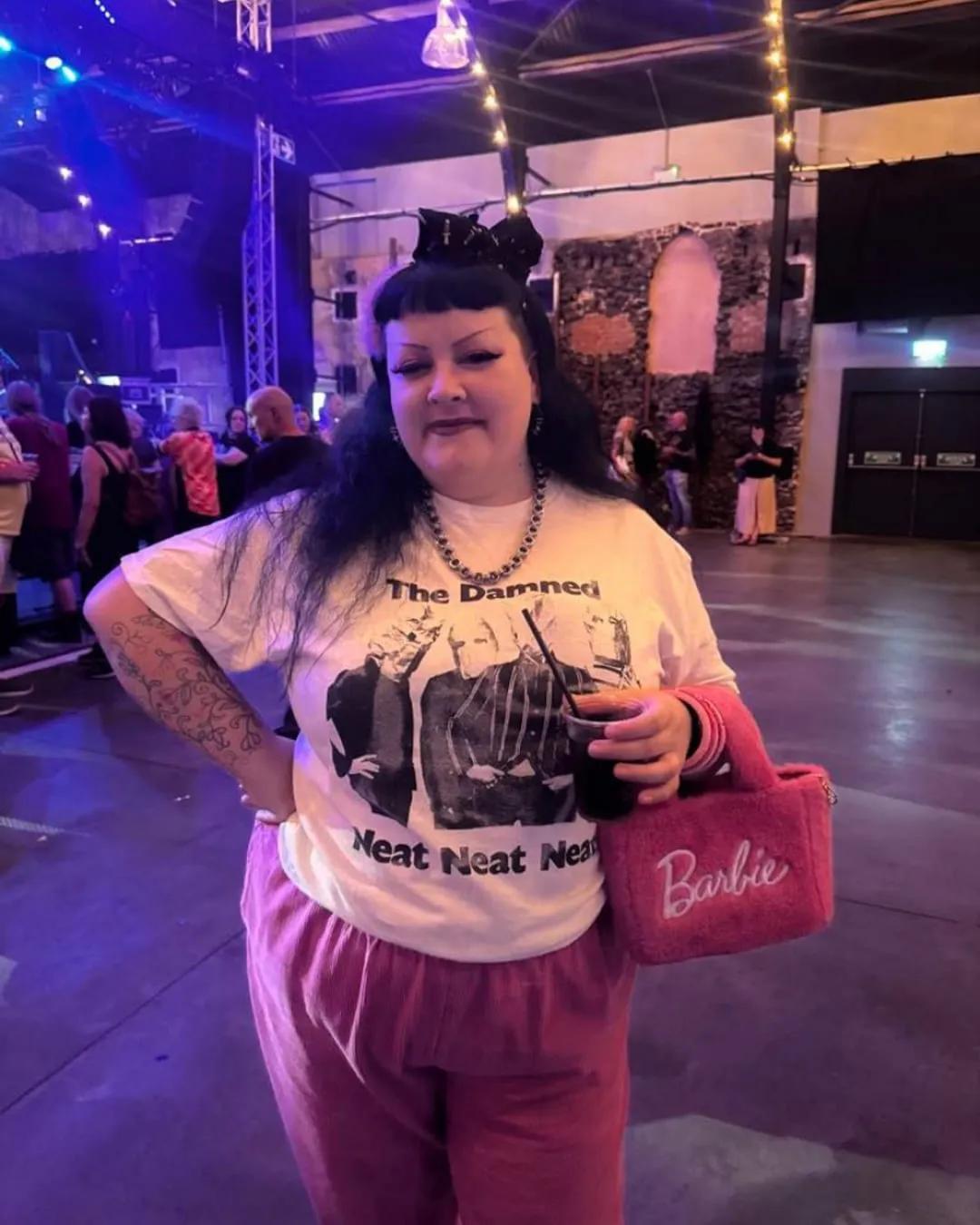 Hannah at a gig, drink in hand, dressed exactly how she wants to be